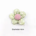Detail of 4cm green polka dot fabric flower with pink striped center for DIY crafts - Green Polka Dot Flower
