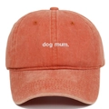 Close-up of dog mum white embroidery on a vintage washed brick red cotton baseball cap - Adjustable / Orange