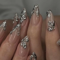 Macro view of almond nails with silver molten metal 3D art on a nude base - Bz1436 Silver-edged Crow Painting / Tool Kit Style
