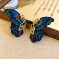 Detail of vintage blue embroidered butterfly hair clip with colorful rhinestones on fabric - Blue Earrings