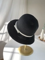 Detailed texture of black woven straw hat with cream ribbon on golden metal stand - M (56-58cm) / Black