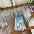 Detail of light blue knitted animal bag with bird pattern and magnetic clasp - Blue Swan - Phone Bag
