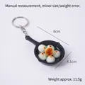 Miniature frying pan keychain featuring fried buns and green onion garnishes - Buns Pan - Keychain