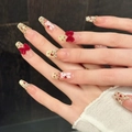 Long trapezoid press-on nails with pink base, gold tips, and red velvet bows - Large (L)