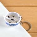 Miniature blue and white porcelain bowl keychain with congee and black beans decor - Black Rice Porridge