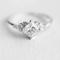 Elegant princess cut cubic zirconia ring with side stones in polished silver finish - US 7 / White Gold