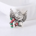 Macro shot of silver angel brooch with colorful enamel flowers and shimmering rhinestones - Silver
