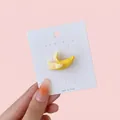 Cute peeled banana resin hair clip accessory shown on a white display card - Banana