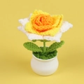Macro detail of hand-knitted crochet rose in a mini ceramic pot with vibrant orange petals - Gradient Yellow