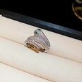 Macro shot of silver snake ring with pavé cubic zirconia and green gemstone eyes - Silver