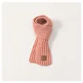 Detail of soft ribbed knit children scarf in pink featuring a vintage leather label - Kids / Pink