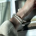 Detailed view of 6mm and 8mm pearl elastic bracelets worn together for a layered look - 6+8mm Pearl Bracelet Set