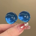 Close-up of minimalist blue spherical resin earrings with gold post on a model hand - 9# Silver Needle-Blue-Large (Transparent Blue Ball)