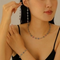Detail view of model wearing a silver clover jewelry set with colorful enamel charms - Silver Four Leaf Clover Set (Necklace+Bracelet+Earrings)