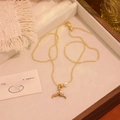 Detail of fishtail pendant necklace with white enamel and pearl in a wooden jewelry box - White