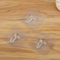 Set van 3 transparante zelfklevende haken met metalen hangers op houten oppervlak - 6x6cm / Transparant (3 Stuks)