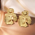 Detailed close-up of golden leaf earrings with textured ridges on a luxury satin tray - Exaggerated Lotus Leaf Earrings (E0879)