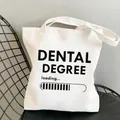 White canvas tote bag with DENTAL DEGREE loading text design for students and dental professionals - C6 Dental Degree Loading