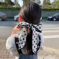 Polka dot silk hair ribbon tied in a bow on a ponytail for a French elegant look - Black White Polka Dot