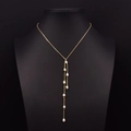 Long gold Y-necklace with teardrop freshwater pearls on a black neck display - Teardrop Pearl Tassel Necklace