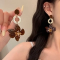 Macro view showing large amber texture flower earrings with yellow crystal core and gold rings - Style 30 Amber Flower Earrings with Silver Post / Gold Brown