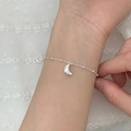Silver bead bracelet featuring a 3D horn pendant shown on wrist against white lace - Croissant Pendant (SL1459)