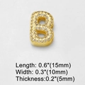 Detailed macro view showing the thickness and size of the golden Zirconia letter B charm - Letter B