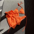 Detail of orange three-piece bikini set with textured fabric and drawstring sarong - Orange Red