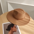Detail of a camel wool fedora hat with leather band on a wooden table with blinds shadow - Adjustable / Khaki