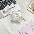 Close-up of white quilted heart pouch with silk ribbon zipper detail on soft background - PU Heart-Creamy White