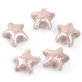 Close-up of five glazed ceramic starfish beads in light pink with white polka dots - Dusty Pink (09#)