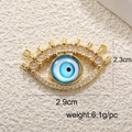 Detailed view of evil eye charm with gold plating and pink crystal, 2.9cm wide - A0255