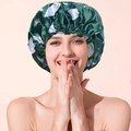 Dark green satin shower cap with white and pink floral pattern on a smiling model - Dark Green White Circle