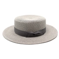 Detailed texture of flat-top boater straw hat featuring elegant side bow and grey ribbon - Gray