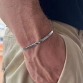 Men's silver-tone stainless steel flat Cuban link chain bracelet shown on male wrist - Silver (Flat Chain)