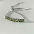 Minimalist adjustable silver bracelet featuring 8 sparkling round green gemstones - Platinum Tone Olive Green (SBP450)