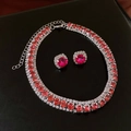 Flat lay view of a red gemstone necklace and stud earrings set on black leather texture - Red Gemstone Set/Necklace+Earrings