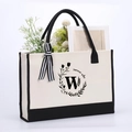 Beige cotton canvas tote bag with black handles, floral W print and summer vibe text - Letter-W