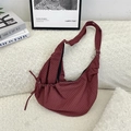 Sac croissant en nylon à carreaux rouges avec bandoulière sur canapé en laine polaire - Rouge