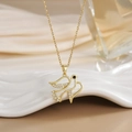 Detail of bird pendant necklace with sparkling cubic zirconia on a white ceramic plate - FN0126 Full Pave Flying Bird Pigeon