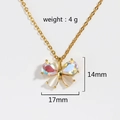 Detail view of gold butterfly pendant with iridescent stones and white shell inlay - Gold