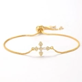 Close-up of golden box chain cross bracelet with pavé cubic zirconia and adjustable slide - Style 10