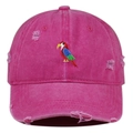 Close-up of colorful parrot embroidery and distressed ripped details on pink baseball cap - Rose Red