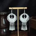 Silver ethnic leaf tassel earrings hanging on a display stand with a dark background - Silver Crescent Hollow Strip Tassel Style (E6073-17)