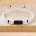 Detail of adjustable white braided bracelet with central black rectangle accent - White (Black Plate)