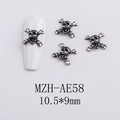Macro view of vintage silver skull and crossbones nail charms, size 10.5x9mm - AE58-Skull Head