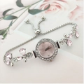 Detailed view of silver flower bracelet watch with pink dial and adjustable slider clasp - Pink