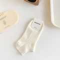 Off-white cotton crew socks with vertical ribbed texture and minimalist brand tag - One Size / Cream