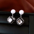Macro view of geometric square pearl earrings with sparkling cubic pendants in vintage style - Silver (Silver Pin)