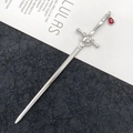 Silver sword hair stick with red teardrop gemstone pendant on a black and white background - Ancient Sword Hairpin / Irregular Water Drop (White K Gold)